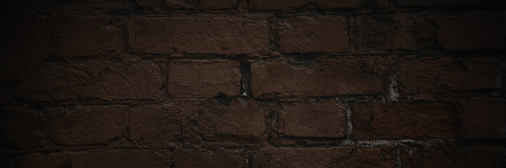 Old brick wall. The texture of weathered grungy brickwork. Panorama of a wall with a rough masonry...
