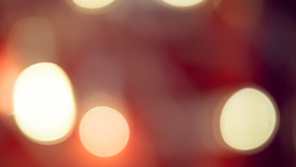 Golden and red bokeh lights create a soft, dreamy background