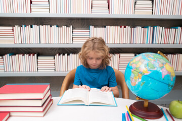 School and students in classroom. Education kids. Child pupil student in the school class. Studying and learning concept. School boy in the library near school supplies. Kid learn geography with globe