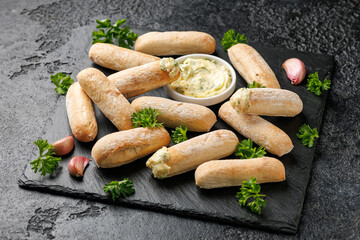 Stone baked ciabatta bread sticks with creamy garlic butter dip.