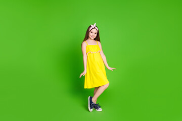 Full length photo of girlish pretty little lady dressed yellow outfit smiling empty space isolated...
