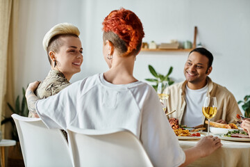 Diverse group enjoying dinner at home, including a loving lesbian couple.