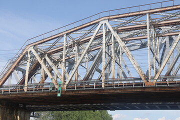 Fototapeta premium metal trusses of a bridge over a river, a bridge over a canal