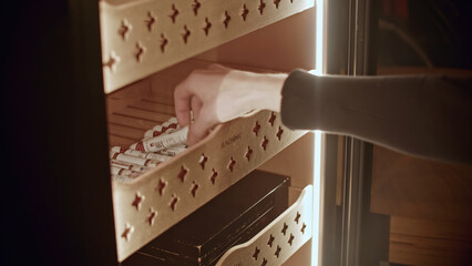 Close-up of cigars. Media. Cigar storage cabinet in specialty store or club. Cigar club with...