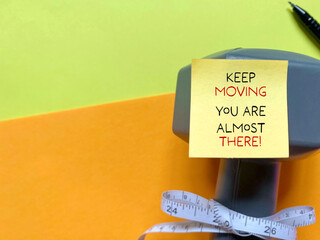 Keep moving you are almost there on adhesive notepaper with dumbbell and tape measure background....