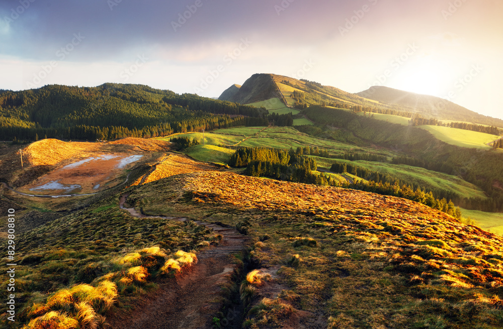 Wall mural Amazing mountain landscape with colorful vivid sunset on the cloudy sky, natural outdoor travel background. Beauty world.