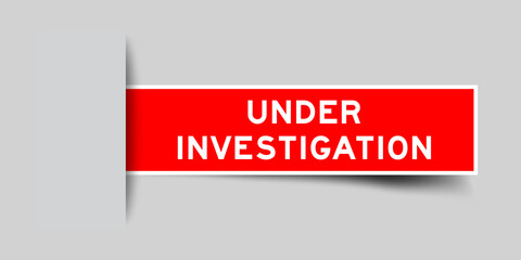 Red color square label sticker with word under investigation that inserted in gray background