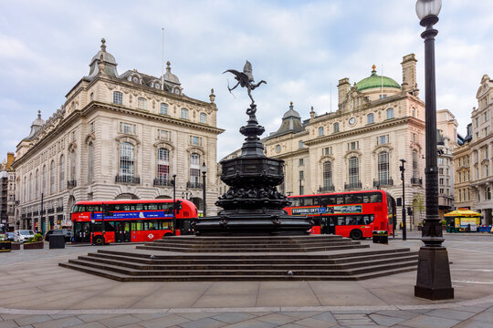 Statue of Eros and double-decker buses on Piccadilly circus, London, UK