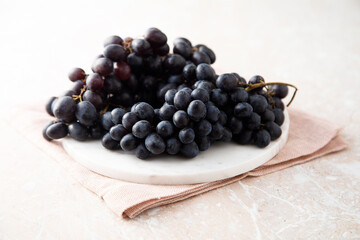 Dark grape on a white desk
