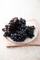 Dark grape on a white desk