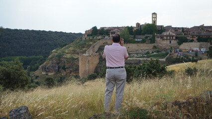 Fototapeta premium A person taking a photo of a medieval village