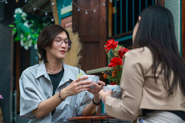 Asian couples playfully bond, sharing affectionate gazes, laughter, and intimate warmth outdoors.