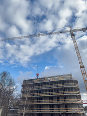 Crane and building under construction. Housing construction, apartment block