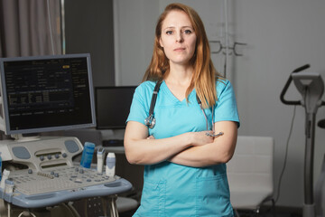 Сardiologist doctor in her office near a medical devices. A rehabilitation doctor in a medical...