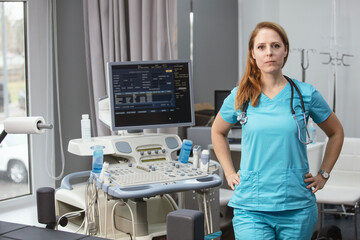 Сardiologist doctor in her office near a medical devices. A rehabilitation doctor in a medical...
