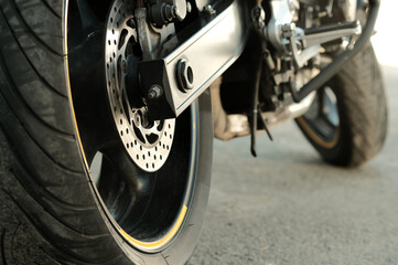 Motorsport. A sports motorbike. Side view from behind. The rear wheel is a close-up. The volume...