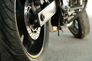 Motorsport. A sports motorbike. Side view from behind. The rear wheel is a close-up. The volume size of the tire.