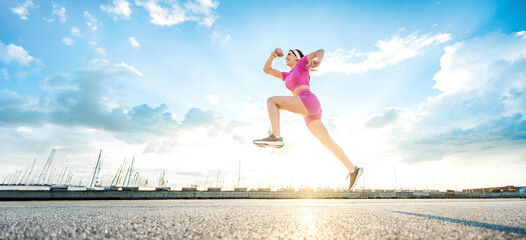 Fit woman exercising outside - Athletic young female doing fitness workout on city street - Sport...