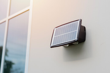 Small solar panel installed on the wall of the house Green energy concept.
