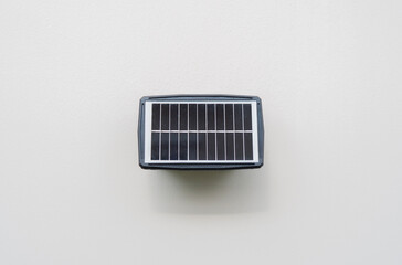 Small solar panel installed on wall at home for use lighting in night time.