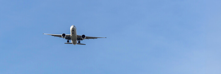 Airplane and sky, the plane is landing. Airplane take off on the blue sky, Aircraft flying on sky background. Passenger plane ready for landing. Low angle view of Airplane flying under blue sky.