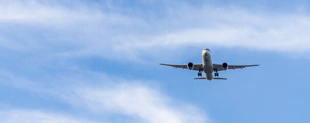 Airplane and sky, the plane is landing. Airplane take off on the blue sky, Aircraft flying on sky background. Passenger plane ready for landing. Low angle view of Airplane flying under blue sky.