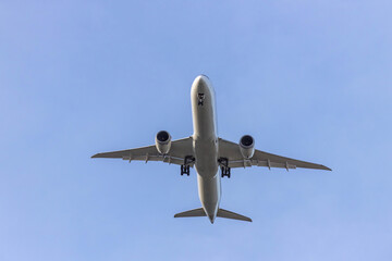 Airplane and sky, the plane is landing. Airplane take off on the blue sky, Aircraft flying on sky background. Passenger plane ready for landing. Low angle view of Airplane flying under blue sky.