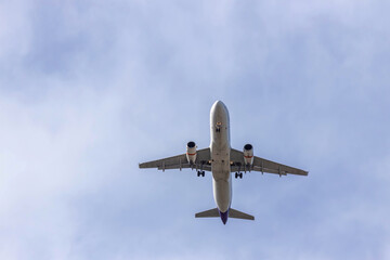 Airplane and sky, the plane is landing. Airplane take off on the blue sky, Aircraft flying on sky background. Passenger plane ready for landing. Low angle view of Airplane flying under blue sky.