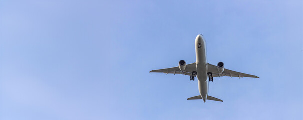 Airplane and sky, the plane is landing. Airplane take off on the blue sky, Aircraft flying on sky background. Passenger plane ready for landing. Low angle view of Airplane flying under blue sky.