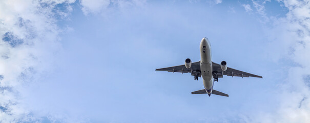 Airplane and sky, the plane is landing. Airplane take off on the blue sky, Aircraft flying on sky background. Passenger plane ready for landing. Low angle view of Airplane flying under blue sky.