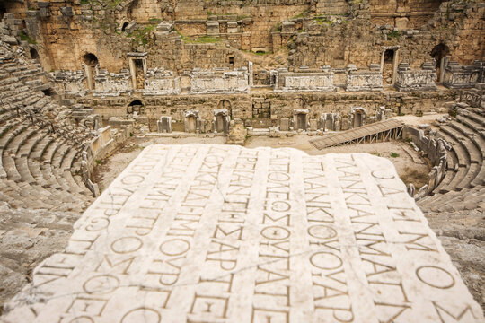 Theatre of Perge Ancient city with and old writing on marble in the composition, Antalya, Turkey.
