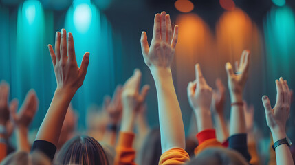 People at conference rising hands up for Q and A session