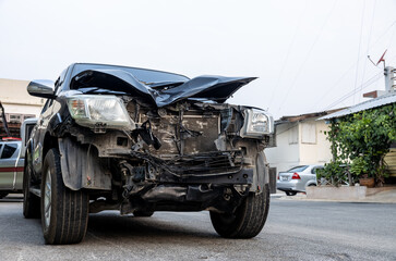 Front of a black car which was destroyed.