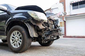 Front of a black car which was destroyed.