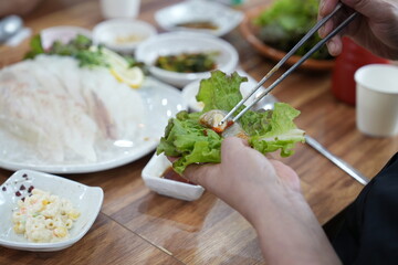 회를 쌈 싸서 먹는 모습