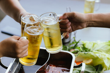 Close-up cropped photos of friends Clinking beer glasses