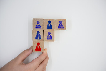 wood blocks sign icons of adding new employees or students. Hand adding a new team member to a...