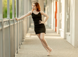 Young Girl Poses In Fashion Style On The Street In A Dress