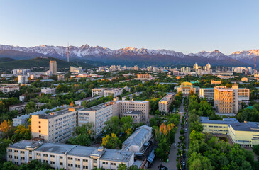 View from a quadcopter of the central part of the Kazakh city of Almaty on a spring morning against the backdrop of a mountain range