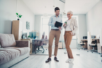 Photo of two business people man analyzing project with trainer aged woman in workplace