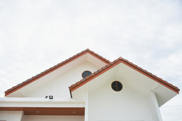 The roof of the house is triangular.