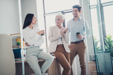 Photo of business people friends have rest speaking in workplace workstation