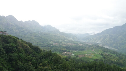 Aerial view, a mountain view with a little fog around it