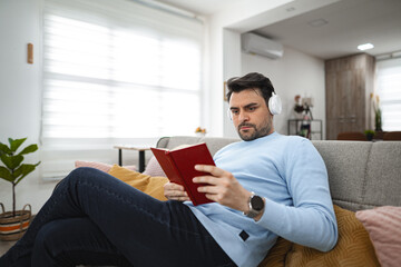Man Reading Book on Couch