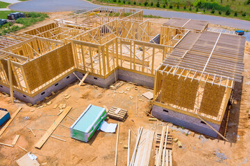 Home residential construction of new house consists of unfinished timber frames wooden beams