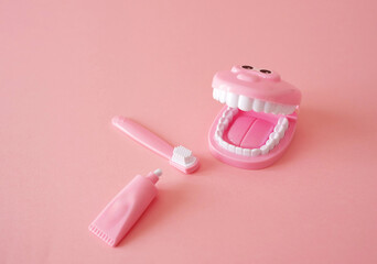 A smiling dental model toy with toothbrush and toothpaste for infant dental care and hygiene on...