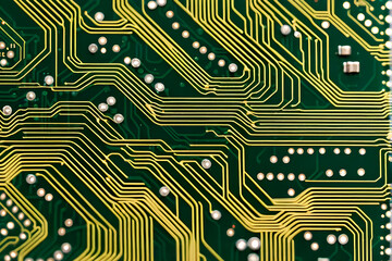 Intricate Technology and Precision Engineering - Close-up of Green Circuit Board with Gold Lines and Soldering Points