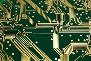 Intricate Technology and Precision Engineering - Close-up of Green Circuit Board with Gold Lines and Soldering Points