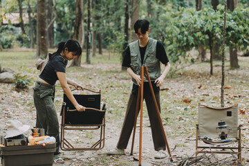 Asian couple sweet in tent inside on they camping trip, traveller relax and sleep togather in out door and camping trip