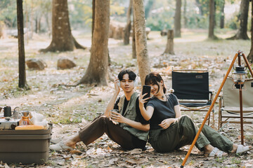 Asian couple sweet in tent inside on they camping trip, traveller relax and sleep togather in out door and camping trip
